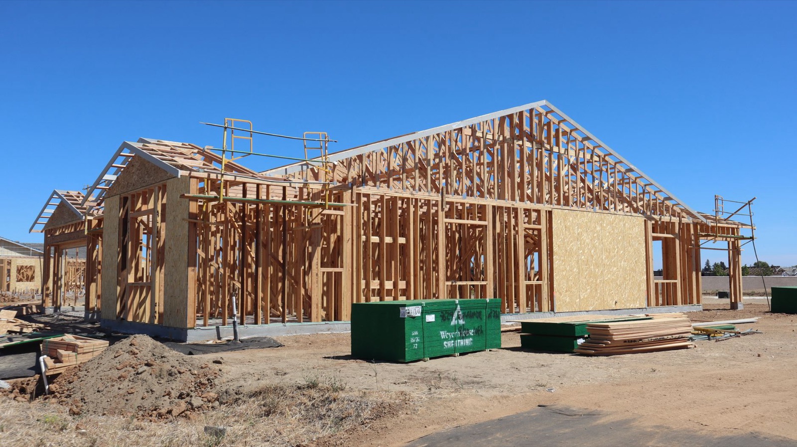 Wood framing of a new single-family home under construction on a sunny day